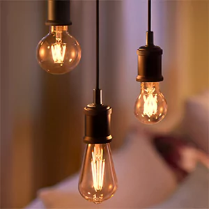 Antique-filament LED pendant bulbs hanging in a row