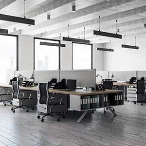 Open-plan office lit by suspended linear LED fixtures